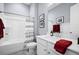 Clean bathroom with white vanity, shower/tub combo, and red accents at 104 True Blue, Summerville, SC 29486