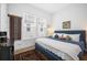 Spacious bedroom with a comfortable blue upholstered bed and ample natural light at 104 True Blue, Summerville, SC 29486