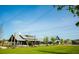 Expansive green lawn area with string lights and community building at 104 True Blue, Summerville, SC 29486