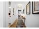 Bright hallway with hardwood floors, stylish rug, and tasteful wall art at 104 True Blue, Summerville, SC 29486
