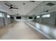 Basement home gym with mirrored walls, ceiling fans, and flat screen TVs at 104 True Blue, Summerville, SC 29486