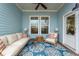 Relaxing covered patio with comfortable seating and ceiling fan at 104 True Blue, Summerville, SC 29486