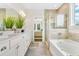 Bathroom with double vanity, soaking tub, and walk-in shower at 137 Winding Grove Ln, Moncks Corner, SC 29461