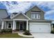 Two-story house with gray siding, white garage door, and stone accents at 137 Winding Grove Ln, Moncks Corner, SC 29461