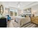 Spacious main bedroom with large windows, neutral decor, and a cozy sitting area at 137 Winding Grove Ln, Moncks Corner, SC 29461