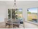 Elegant dining room with glass table, wicker chairs, and stunning marsh views at 1505 Marsh Haven, Johns Island, SC 29455