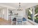 Bright dining area with a glass table, kitchen access, and views of the marsh at 1505 Marsh Haven, Johns Island, SC 29455