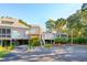 Elevated home with a light beige exterior, surrounded by lush landscaping at 1505 Marsh Haven, Johns Island, SC 29455