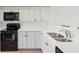 Modern kitchen with white cabinets, black appliances, and quartz countertops at 1505 Marsh Haven, Johns Island, SC 29455