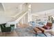 Open living room with light wood floors, comfortable seating, and a high ceiling at 1505 Marsh Haven, Johns Island, SC 29455
