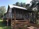 Elevated cabin with a wooden deck and fence at 1661 Lonnie Taylor Ln, Wadmalaw Island, SC 29487