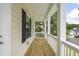 Covered porch with wood flooring and white railings at 2088 Blue Bayou Blvd, Johns Island, SC 29455