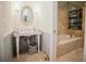Elegant bathroom with a pedestal sink, bathtub, and marble tile at 2860 Old Drake Dr, Johns Island, SC 29455