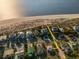 Aerial view of beachfront homes, road, and beach access at 3131 Palmetto Blvd, Edisto Island, SC 29438