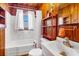 Small bathroom with white sink and bathtub, and wood paneled walls at 3131 Palmetto Blvd, Edisto Island, SC 29438
