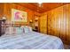 Main bedroom with a queen-size bed and wood paneled walls at 3131 Palmetto Blvd, Edisto Island, SC 29438