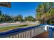 Deck overlooking a street with palm trees and houses at 3131 Palmetto Blvd, Edisto Island, SC 29438