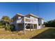 Elevated beach house with screened porch and a spacious yard at 3131 Palmetto Blvd, Edisto Island, SC 29438