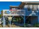 Elevated beach house with wraparound deck, offering peaceful views at 3131 Palmetto Blvd, Edisto Island, SC 29438