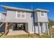 Elevated beach house exterior with gray siding, covered patio, and spacious deck at 3131 Palmetto Blvd, Edisto Island, SC 29438