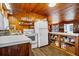 White appliances and wood cabinets fill this charming kitchen at 3131 Palmetto Blvd, Edisto Island, SC 29438