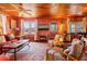 Open living room with wood paneling and a fireplace at 3131 Palmetto Blvd, Edisto Island, SC 29438