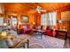 Living room with wood paneling, hardwood floors, and comfy seating at 3131 Palmetto Blvd, Edisto Island, SC 29438