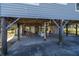 Concrete patio under house with picnic table and seating at 3131 Palmetto Blvd, Edisto Island, SC 29438