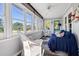 Relaxing sunroom with wicker furniture and ample natural light at 3131 Palmetto Blvd, Edisto Island, SC 29438
