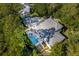 Aerial view of home showcasing pool, patio, and lush landscaping at 371 Live Palmetto Bluff, Mount Pleasant, SC 29464