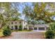 Two-story home exterior with three-car garage and mature trees at 371 Live Palmetto Bluff, Mount Pleasant, SC 29464