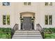 Elegant front entry with double doors, iron railings, and potted plants at 371 Live Palmetto Bluff, Mount Pleasant, SC 29464
