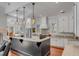 Modern kitchen with white cabinets, granite countertops, and island at 371 Live Palmetto Bluff, Mount Pleasant, SC 29464