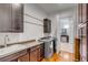 Laundry room with washer, dryer, sink, and ample cabinet storage at 371 Live Palmetto Bluff, Mount Pleasant, SC 29464