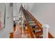 Elegant wooden staircase with wrought-iron railing, leading to upper level at 371 Live Palmetto Bluff, Mount Pleasant, SC 29464