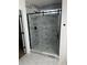 Modern gray marble shower with a frameless glass door and hexagon floor tiles at 5164 Torrey Ln, Summerville, SC 29485