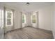 Charming bedroom with light walls, wood-look floors and three windows at 5748 Pilgrim Ave # D, Hanahan, SC 29410