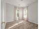 Well-lit bedroom with wood-look floors and two windows at 5748 Pilgrim Ave # D, Hanahan, SC 29410