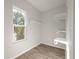 White shelving in spacious closet with wood-look floors and window at 5748 Pilgrim Ave # D, Hanahan, SC 29410