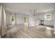 Open concept kitchen and living area with white cabinets and hardwood floors at 5748 Pilgrim Ave # D, Hanahan, SC 29410