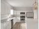 Modern kitchen with white cabinets, marble countertops, and stainless steel appliances at 5748 Pilgrim Ave # D, Hanahan, SC 29410
