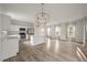 Open concept kitchen and living area with white cabinets and hardwood floors at 5748 Pilgrim Ave # D, Hanahan, SC 29410