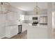 Modern kitchen with white cabinets, marble countertops, and stainless steel appliances at 5748 Pilgrim Ave # D, Hanahan, SC 29410