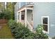 Front entrance of a charming home with white porch and landscaping at 5748 Pilgrim Ave # D, Hanahan, SC 29410