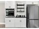 White shaker cabinets, black countertops, and stainless steel appliances at 1344 Hard Pinch Rd, Moncks Corner, SC 29461