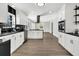 Open concept kitchen with white cabinets and black countertops at 1344 Hard Pinch Rd, Moncks Corner, SC 29461