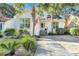 Charming white house with a light teal door, surrounded by lush landscaping at 1515 Barquentine Dr, Mount Pleasant, SC 29464