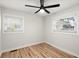 Well-lit bedroom with hardwood floors and two windows at 1897 Halo Ln, Charleston,  29407