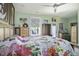Main bedroom with floral bedding, dresser, and access to backyard at 3034 Cane Slash Rd, Johns Island, SC 29455