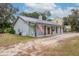 View of the home's side, showing the metal roof and landscaping at 3034 Cane Slash Rd, Johns Island, SC 29455